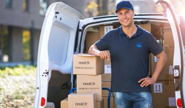 Delivery man standing in front of his van